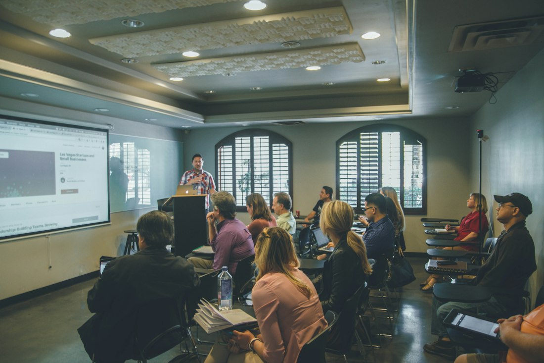 Participants attending an entrepreneurship workshop with a projector screen