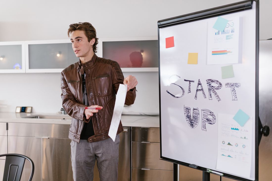 Founder presenting a startup plan on a flipchart