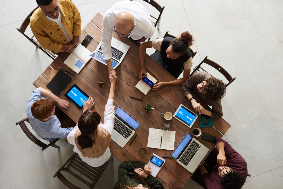 Startup team working on laptops seen from above